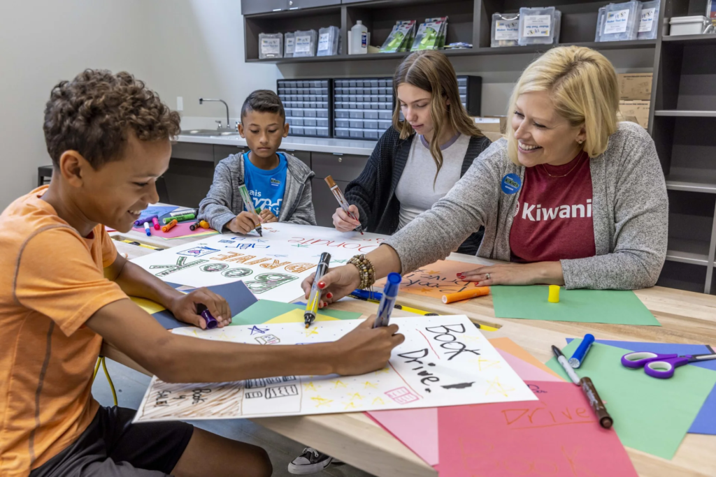 Denham Springs Kiwanis volunteers helping children with a hands-on community service activity.